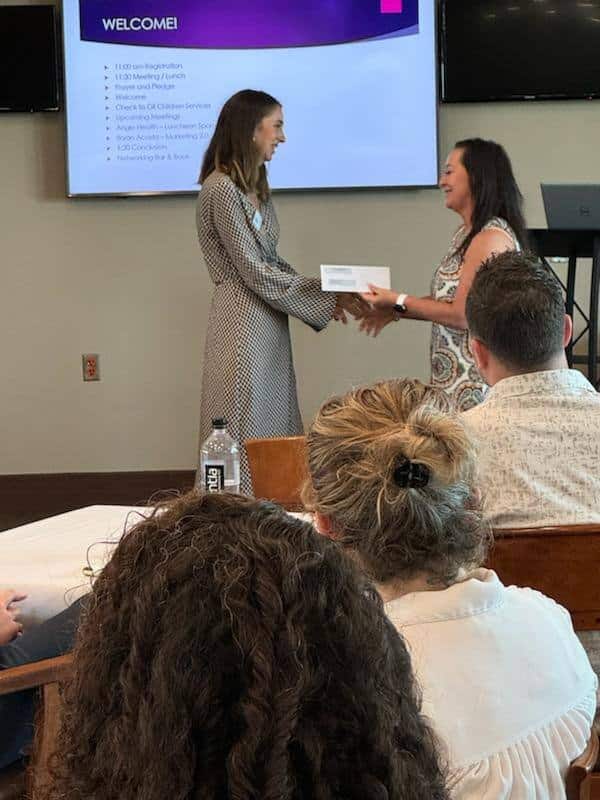 Audra Sullivan giving Gill's Children a check from Nabip