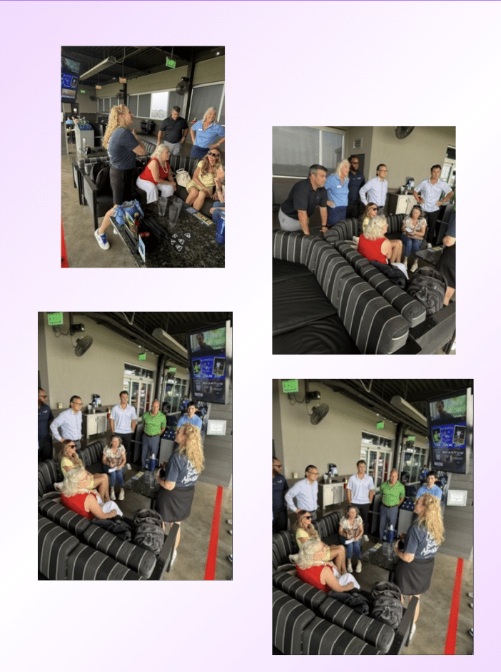 Group of adults gathered and talking in a bowling alley lounge with striped couches and wall-mounted TVs.