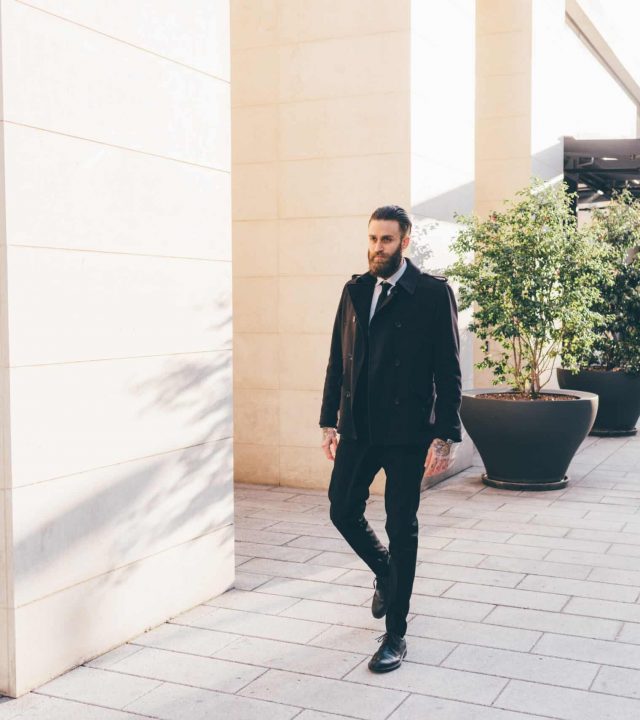 Young handsome caucasian bearded businessman walking